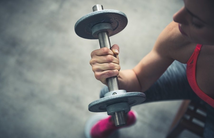 Closeup On Fitness Woman Workout With Dumbbell In Urban Loft Gym