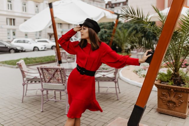 Dreamy 24 year old girl looks to distance with hope. Photo in European city of stylish model in bla
