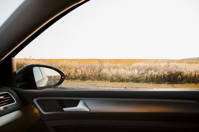 sunny-view-field-from-elegant-car